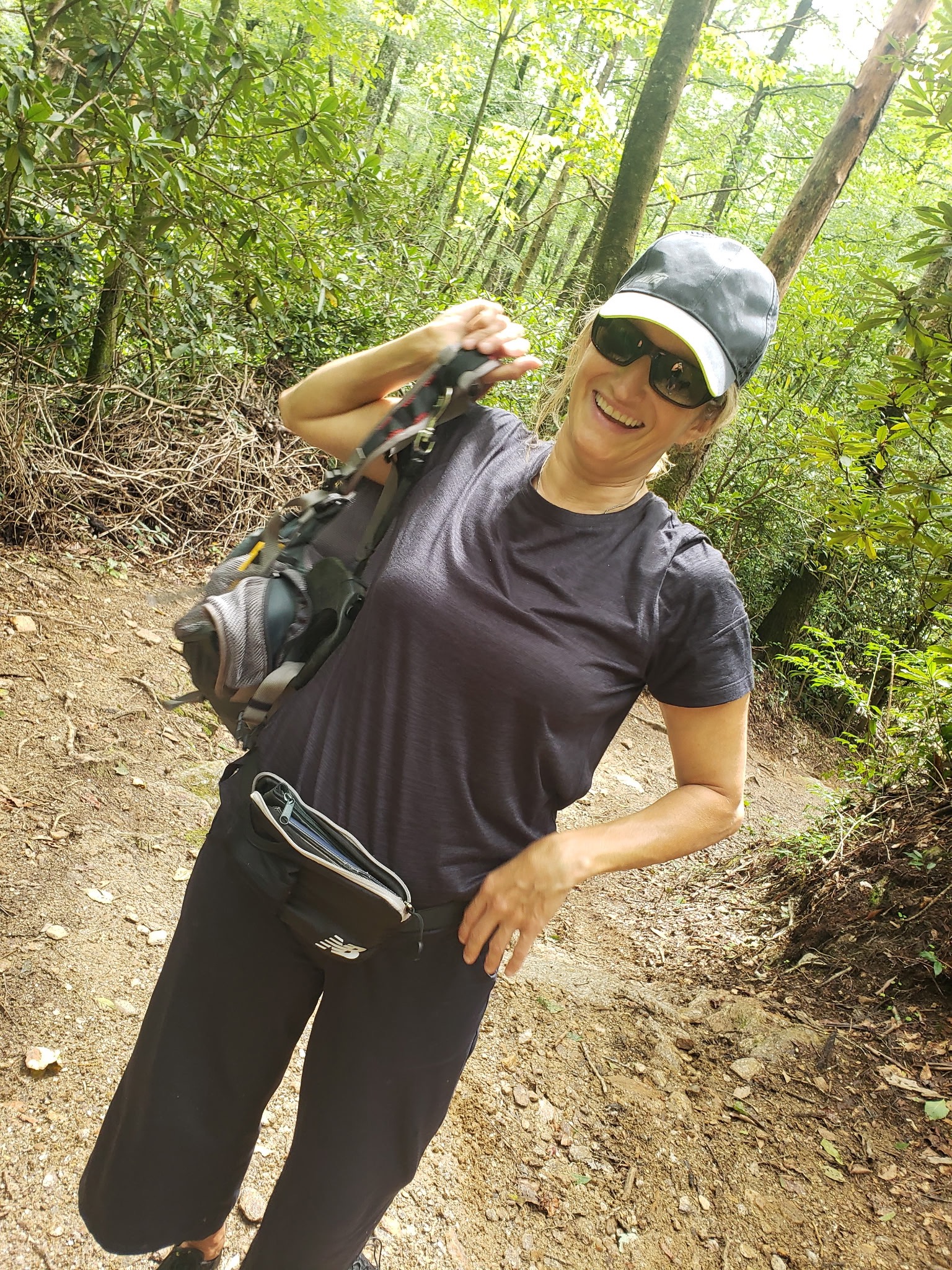 Heidi smiling on a wooded trail